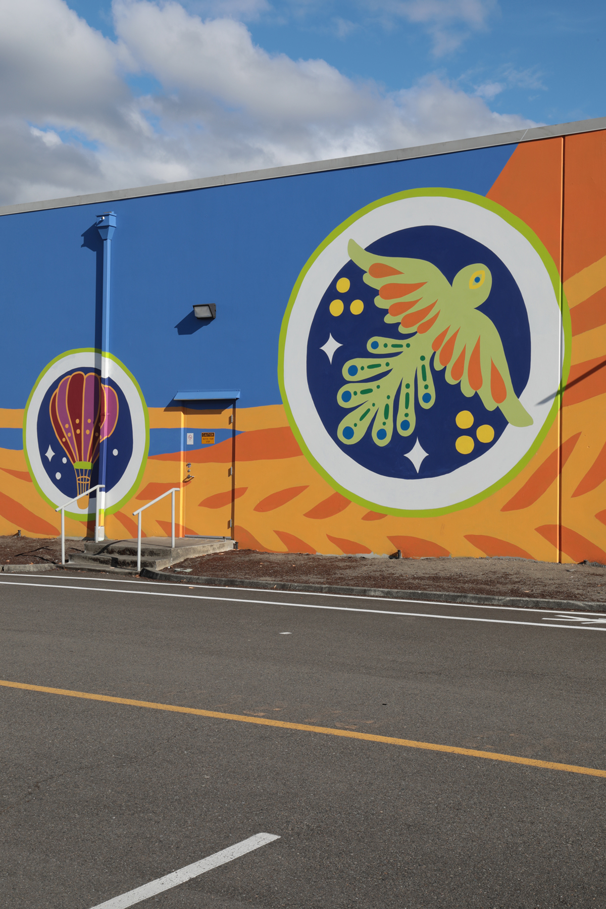 Detailed view of a wall mural featuring a hot air balloon and large stylized bird.
